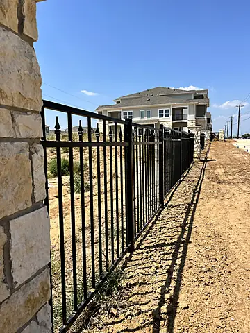Spear-top run off a stone entry column, New multifamily